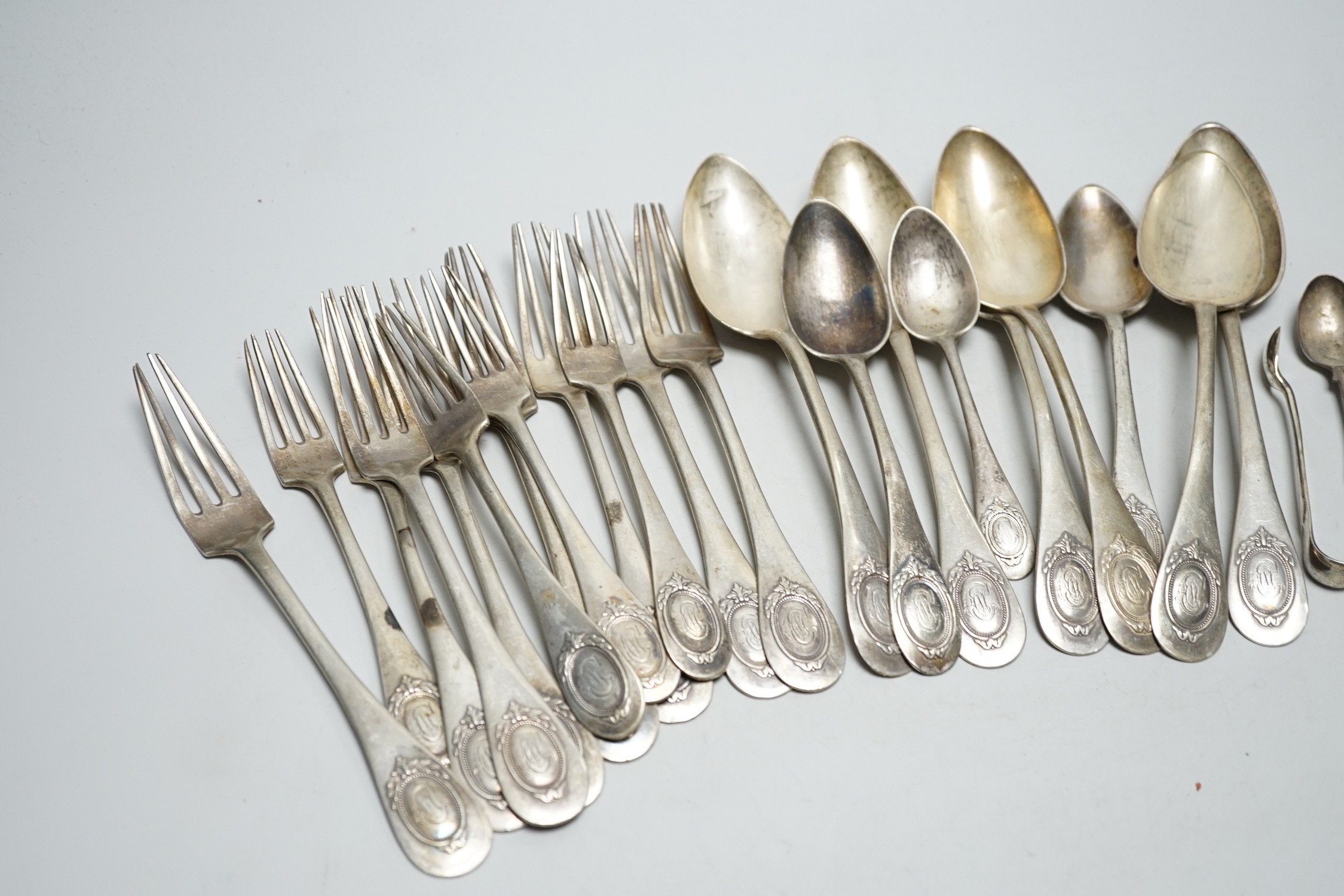 Twenty assorted items of German 800 standard white metal cutlery and three English silver items of cutlery, 39.1oz.